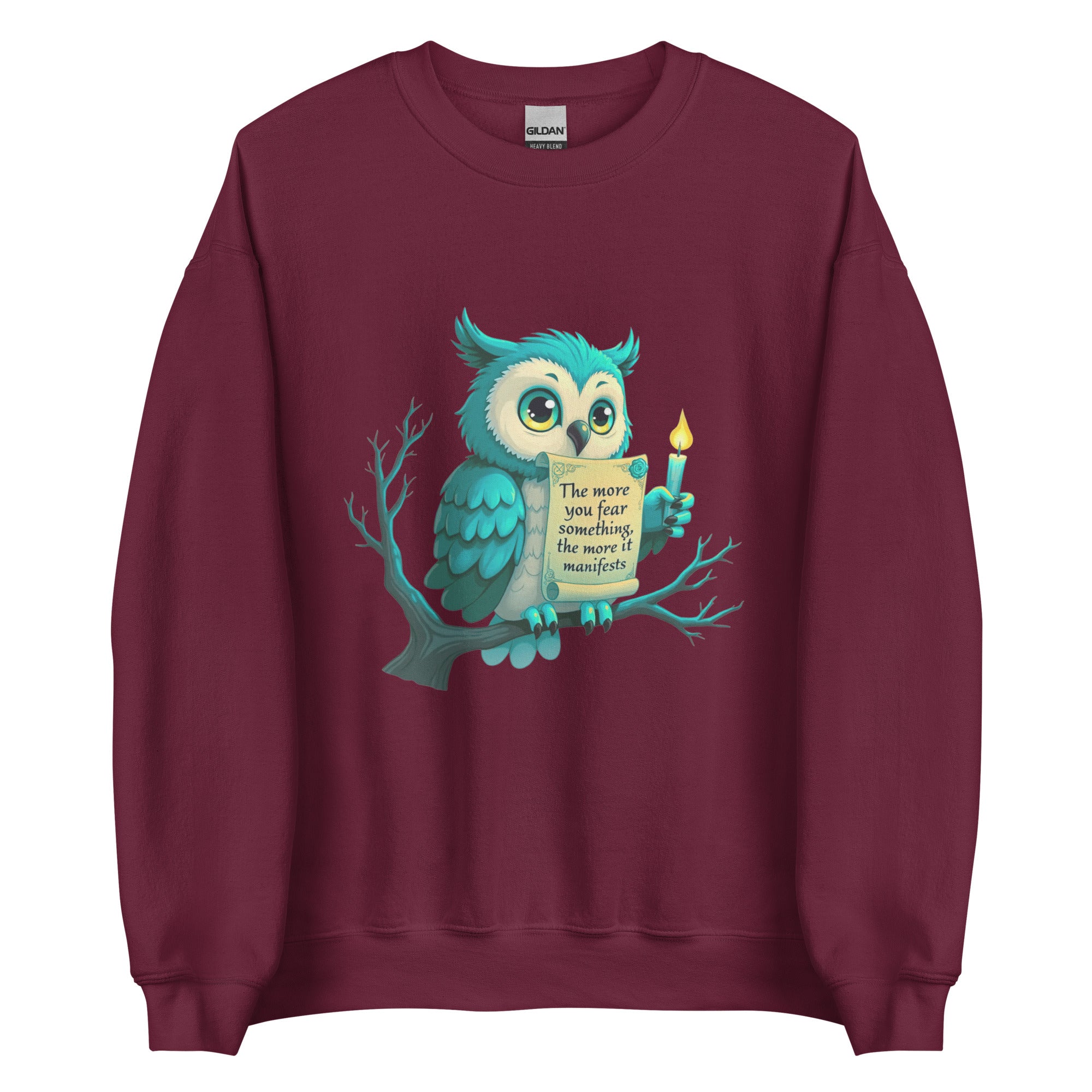 Teal owl perched on a bare branch holding a manifestation scroll on a sweatshirt.