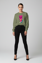 Person wearing a green sweatshirt with a colorful face design on a plain background