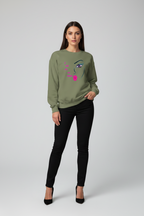 Woman wearing a green sweatshirt with a face design on a gray background