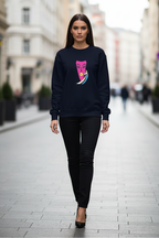 Woman wearing a black sweatshirt with a colorful graphic on a city street.