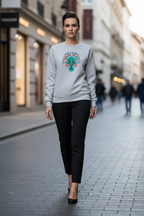 Woman walking on a city street wearing a gray sweatshirt with a colorful alien design.