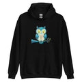 Front view of black unisex heavy blend hoodie featuring a white owl graphic and manifestation quote.