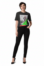 Woman wearing a black t-shirt with a graphic design and black pants on a white background