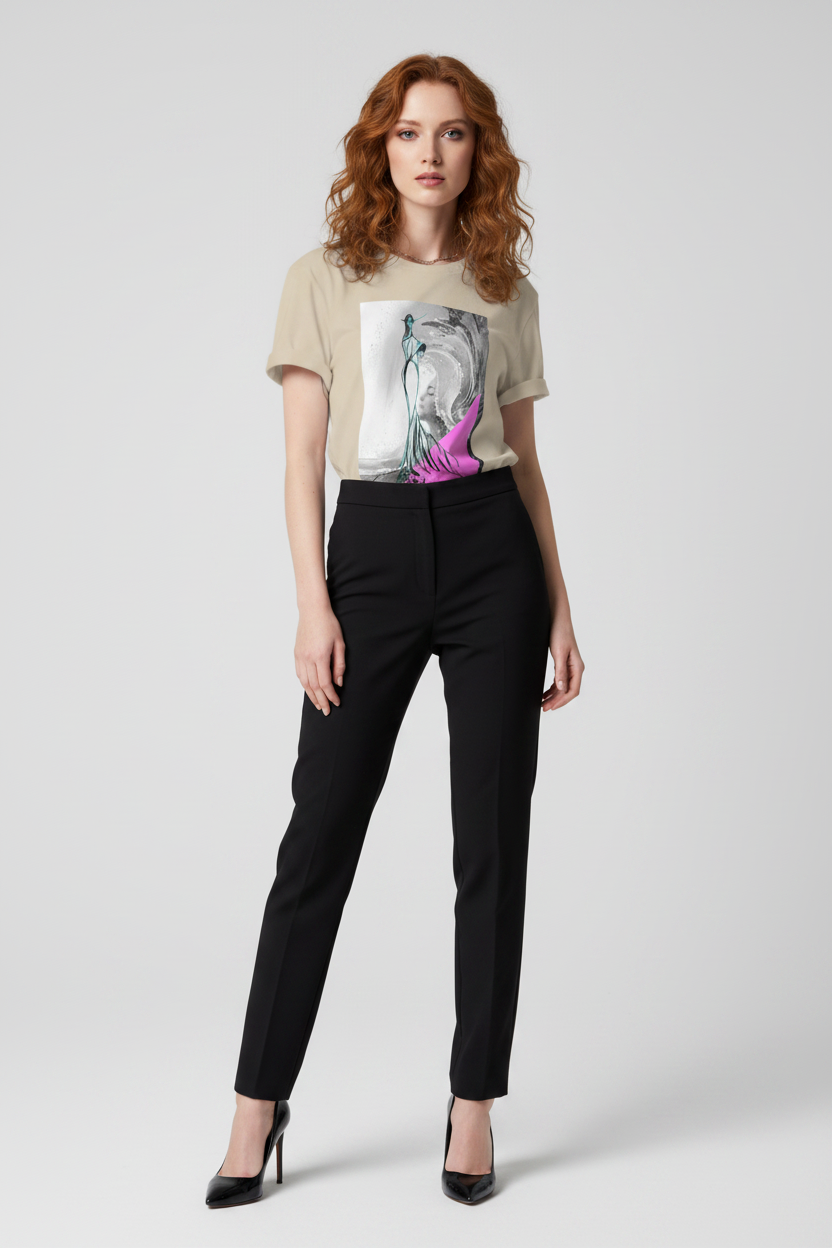 Woman wearing a graphic t-shirt and black pants on a white background