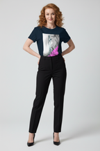 Woman wearing a black t-shirt with a graphic design and black pants on a white background