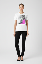 Woman wearing a white t-shirt with a graphic design and black pants on a white background