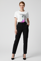 Woman wearing a white t-shirt with a graphic design and black pants on a white background