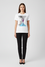Woman wearing a white t-shirt with a graphic design on a plain background