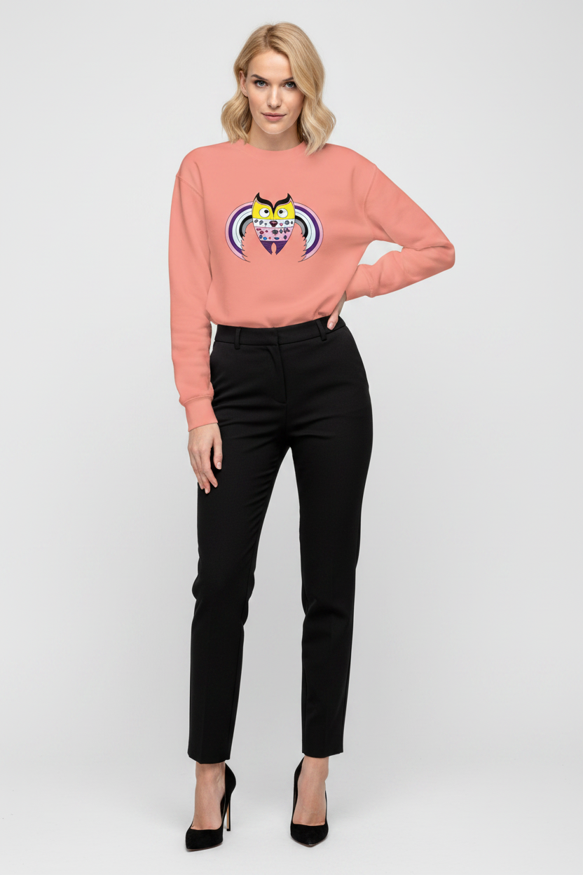 Woman wearing a pink sweater with a graphic design and black pants on a white background
