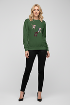 Woman wearing a green sweater with embroidery and black pants on a white background
