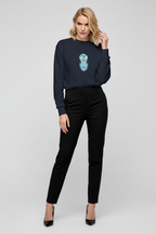 Woman wearing a navy blue sweater with a graphic design on a white background