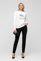Woman wearing a white sweatshirt with text and black pants on a white background
