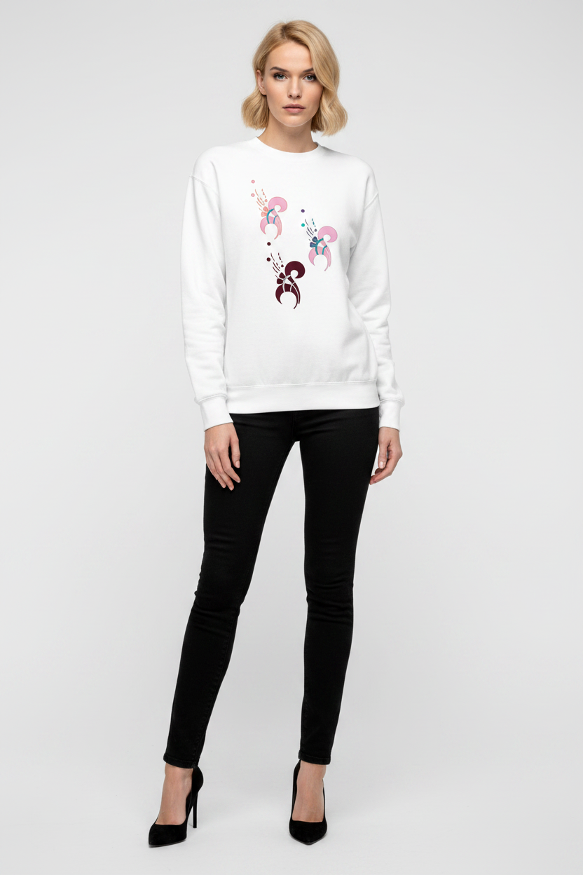 Woman wearing a white sweatshirt with a floral design and black pants on a white background