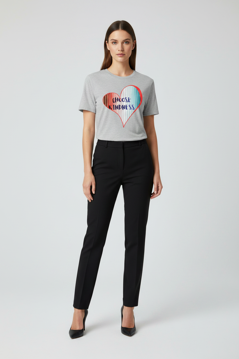 Woman wearing a gray t-shirt with a colorful heart design and black pants on a white background