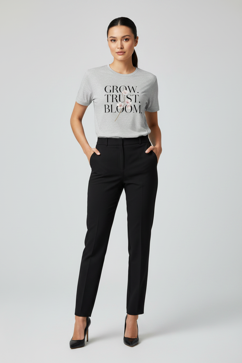 Woman wearing a gray t-shirt with text and black pants on a white background
