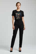 A woman modeling a black short-sleeve graphic t-shirt with a colorful dog print, paired with black trousers and black heels, against a light gray studio background.