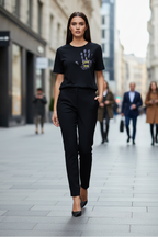 Woman in a black outfit walking on a city street