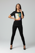 Woman wearing a black t-shirt with a colorful graphic design on a plain background