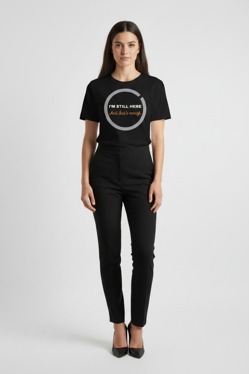 Person wearing a black t-shirt with text and graphic design on a plain background