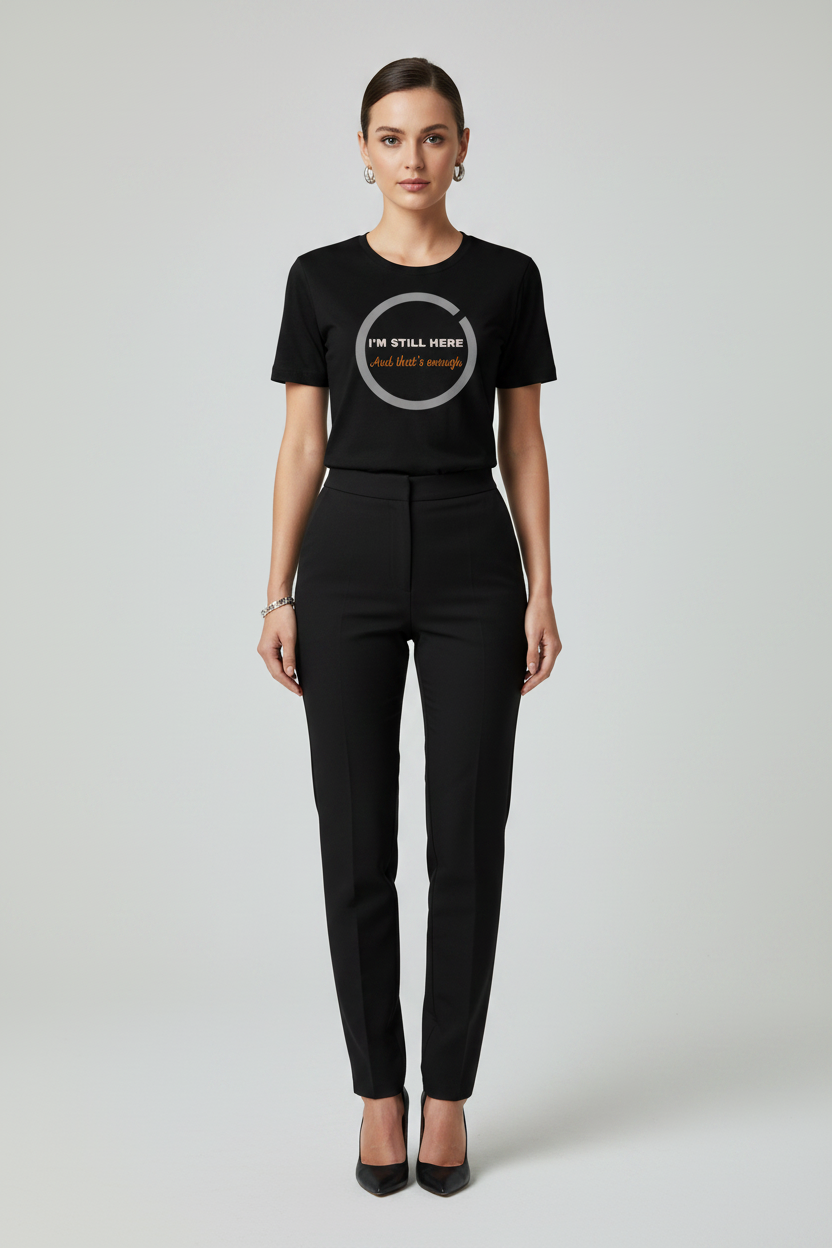 Person wearing a black t-shirt with text and black pants on a white background