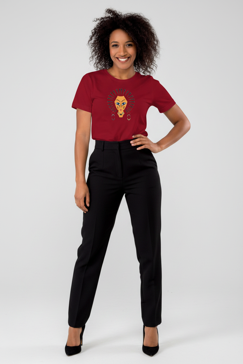 A woman modeling a short-sleeve crewneck t-shirt in dark red with a graphic of a lion cub on the chest, paired with black trousers and black heels, against a light gray studio background.