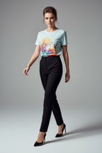 Woman wearing a light blue t-shirt with a colorful design and black pants on a gray background