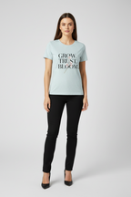Woman wearing a light blue t-shirt with text on a white background