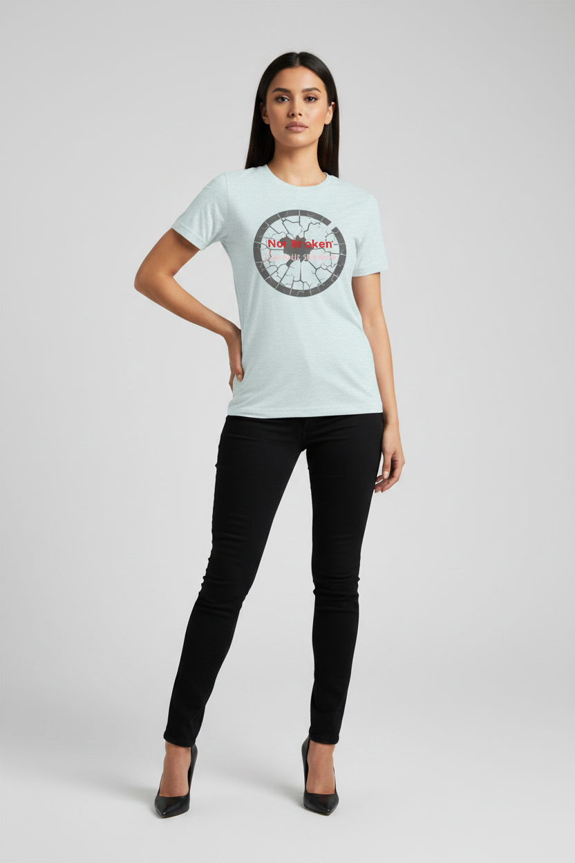 Woman wearing a light blue t-shirt with a logo on a gray background