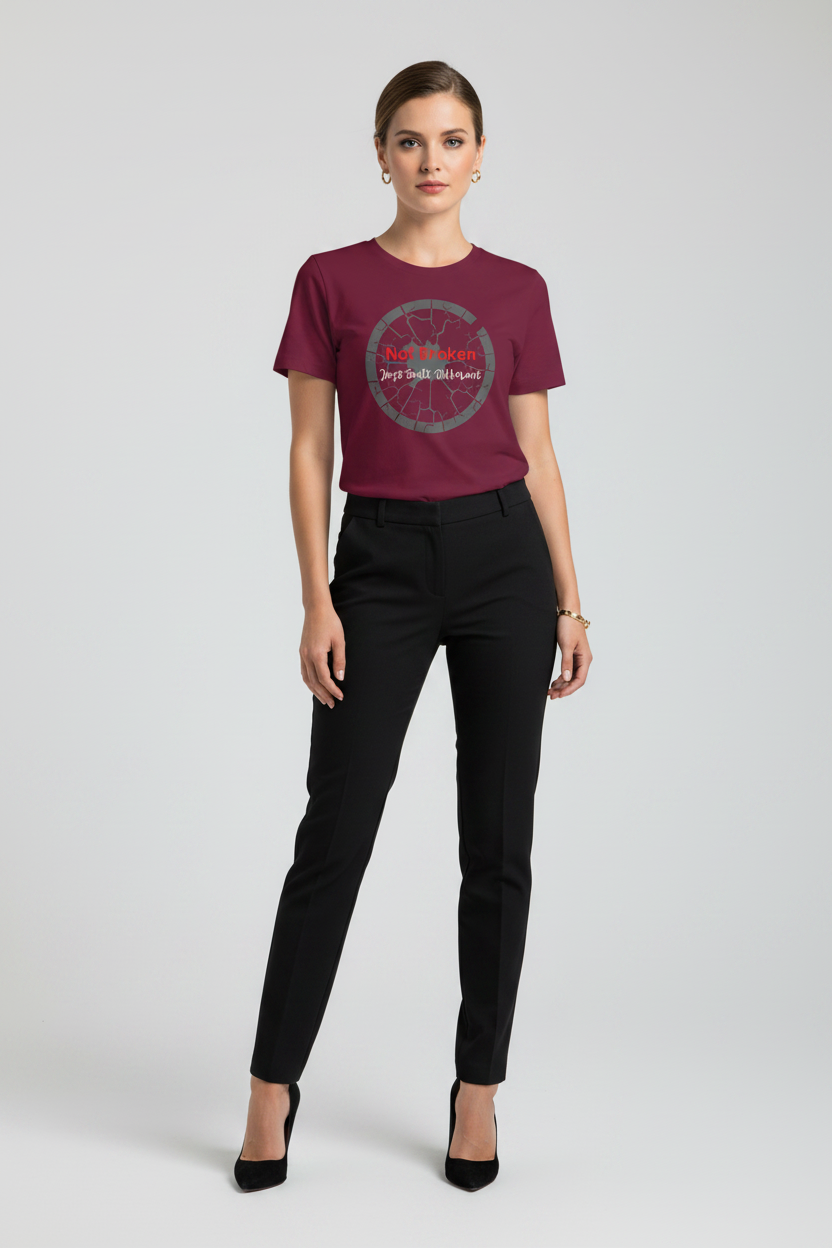 Woman wearing a maroon t-shirt with a graphic design on a plain background