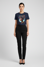 A woman modeling a navy blue short-sleeve graphic t-shirt with a colorful portrait print on the front, paired with black pants and black heels, against a light gray studio background.