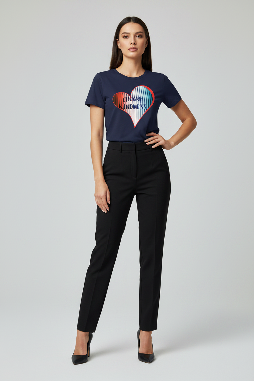 Woman wearing a navy blue t-shirt with a colorful heart design and black pants on a light gray background