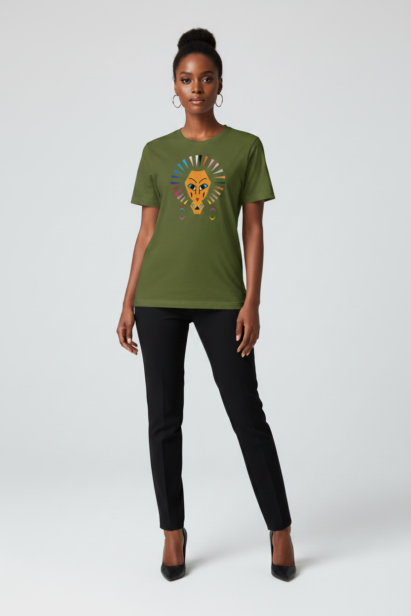 A woman modeling an olive green short-sleeve t-shirt with a colorful graphic of a lion head and sunburst on the chest, paired with black pants and black heels, against a light gray studio background.