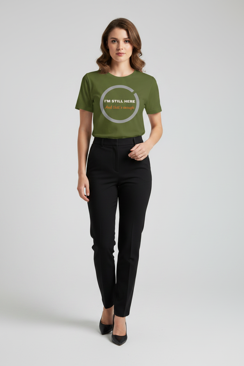 Woman wearing a green t-shirt with text and black pants on a light gray background