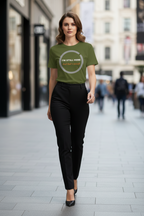 Woman wearing a green t-shirt with text on a city street