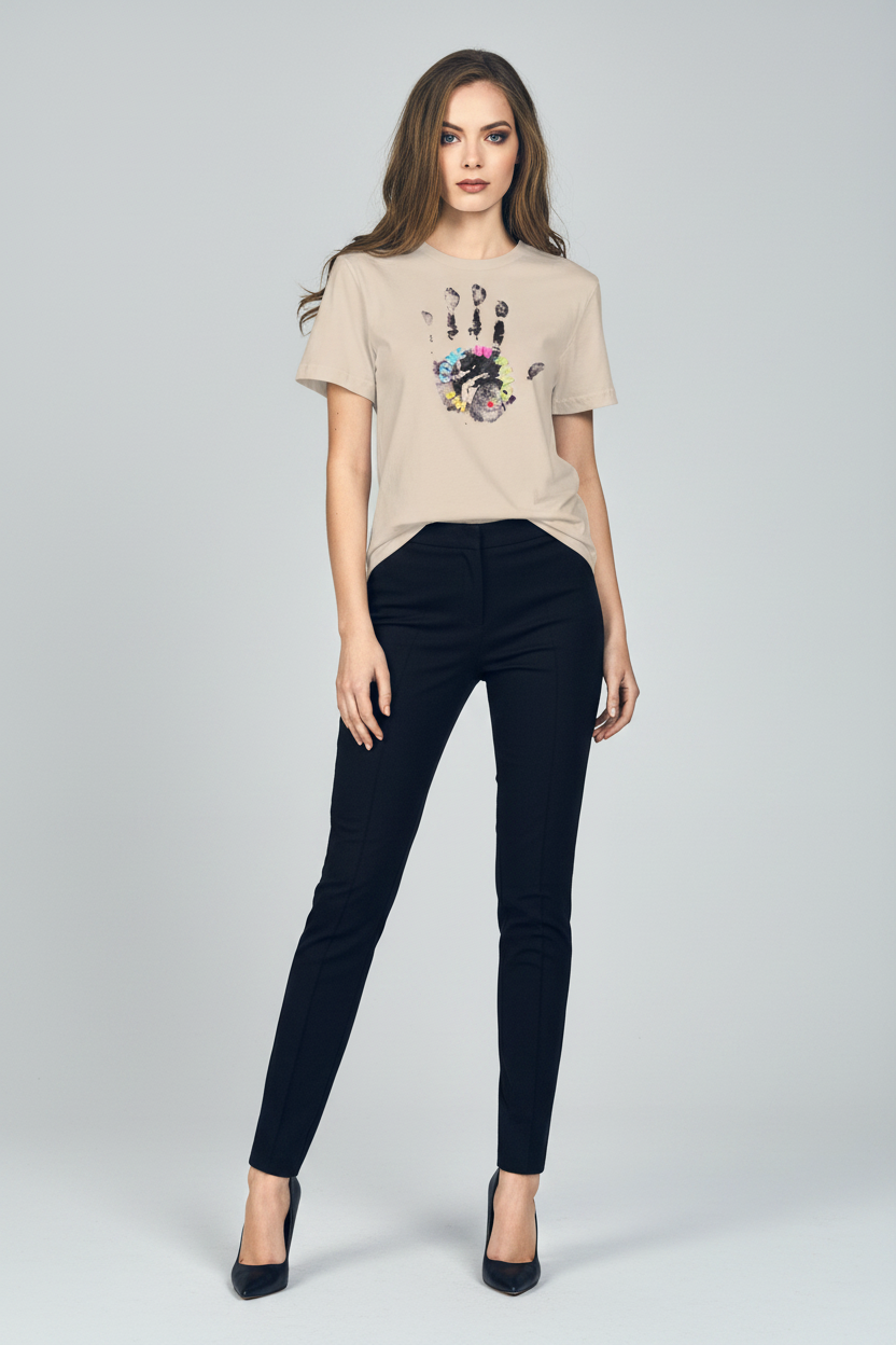 Woman wearing a beige t-shirt with a colorful design and black pants on a white background