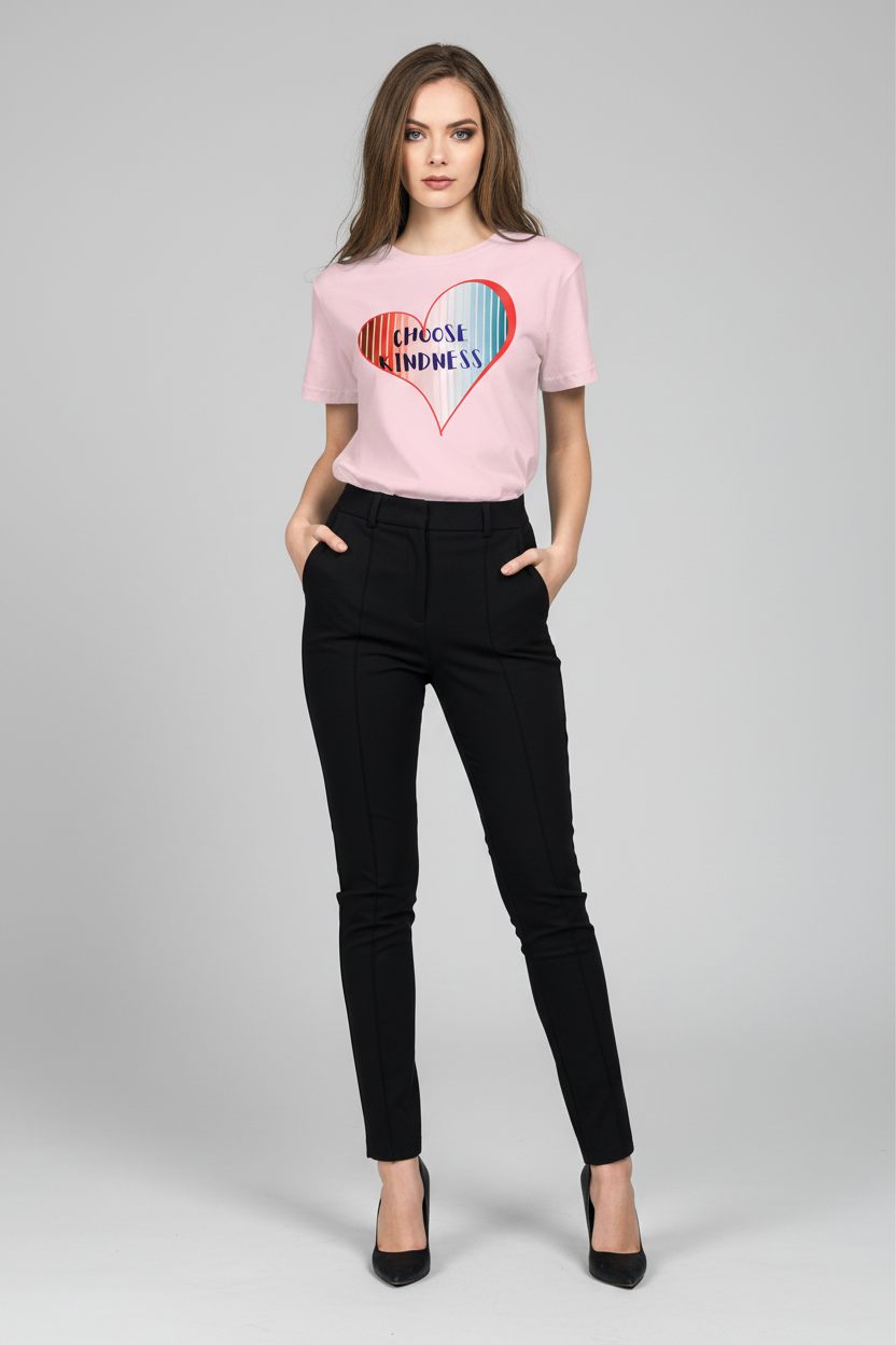 Woman wearing a pink t-shirt with a colorful heart design and black pants on a light gray background