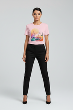 Woman wearing a pink t-shirt with a colorful graphic and black pants on a light gray background