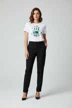 Woman wearing a white t-shirt with text and black pants on a white background